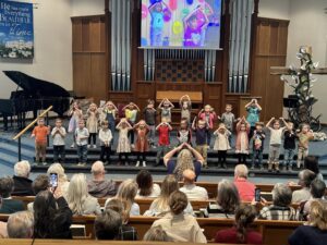 Kids singing at the front of the church