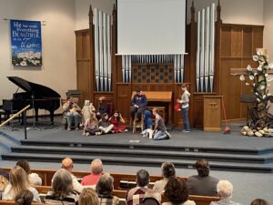 Kids performing a skit at the front of the church