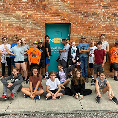 Group of kids by a brick wall