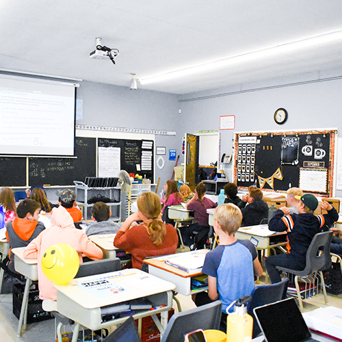 Kids sitting at their desks in a classroom