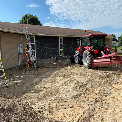 Tractor moving dirt for the new school addition