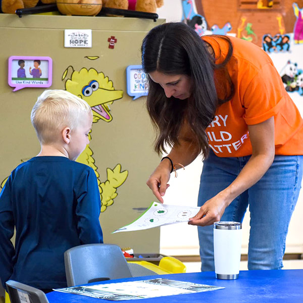 Female teacher assisting a boy