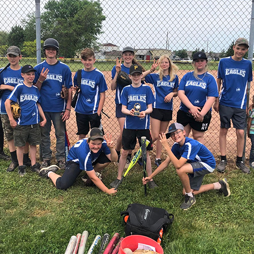 Baseball team photo outside in front of the baseball diamond